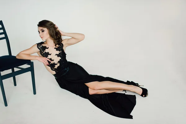 Individuality. Thoughtful Elegant Lady in Black Prom Evening Dress. Studio retouched photo.