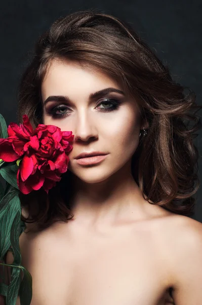 Beautiful sexy stylish young adult in lingerie with nice bouquet of pink peonies. Studio retouched shot. Close up. — Stock Photo, Image