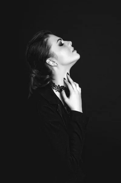 Emotional portrait of a young beautiful girl expressing fear, anger, crying, posing over black background. Perfect skin and hair. Close up. Black and white (monochrome) retouched studio shot — Stock Photo, Image