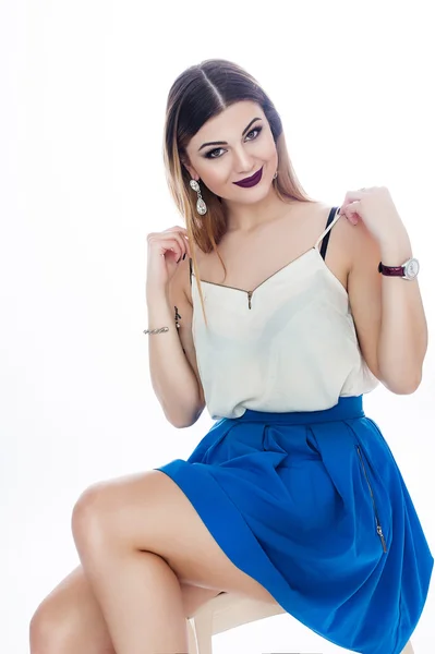 Bright positive fashion studio portrait of pretty young girl with purple lips, bright make up, sexy body, stylish trendy outfit: blue skirt, smart casual, cute emotions, color pop, white background. — Stock Photo, Image