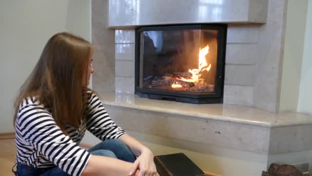 Teenage Girl Striped Sweater Sitting Front Fireplace Watching Flame — Stock Video