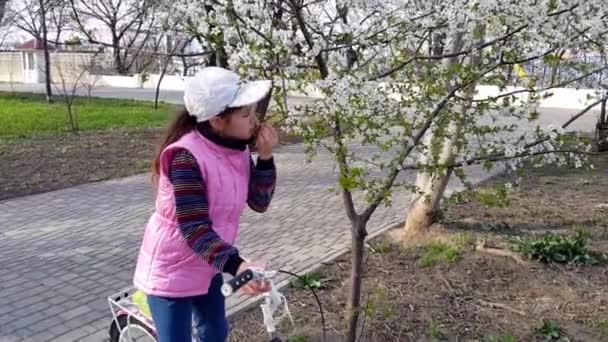Girl Bicycle Pink Sleeveless Jacket Sniffs Flowers Branch Sunny Spring — Stock Video