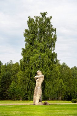 Sculpture standing near tree in Salaspils Latvia