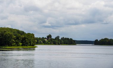 Serene river flowing through Aukstaitija National Park landscape 