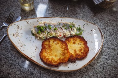 İçinde balık ve patatesli krep olan tabaklar Klaipeda.