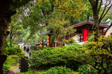 Çin Suzhou 'daki geleneksel binaları çevreleyen yemyeşil alanlar.