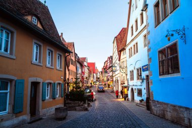 Colorful buildings lining cobblestone street in Rothenburg