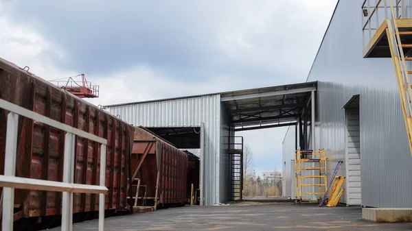 Cargo train is entering a warehouse terminal for loading