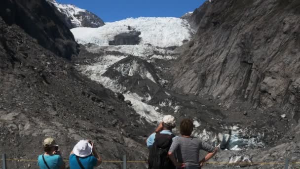 Toeristen nemen foto's van franz josef gletsjer — Stockvideo