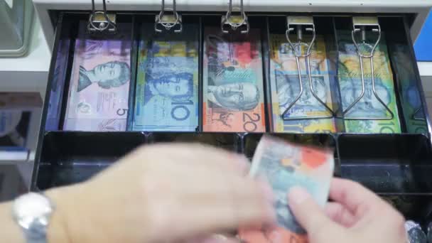 Shop assistant taking currency notes from cash register — Stock Video