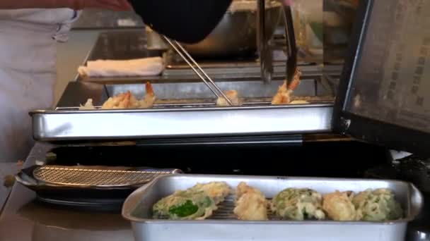 Une serveuse compose une commande de crevettes tempura et légumes dans un restaurant — Video