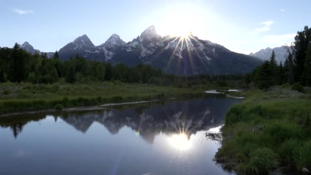 Sun setting behind grand teton from schwabachers landing in grand teton national park — Stock Video