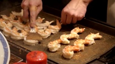 Bir satıcı Kyoto 'daki Nishiki pazarında karides pişiriyor.