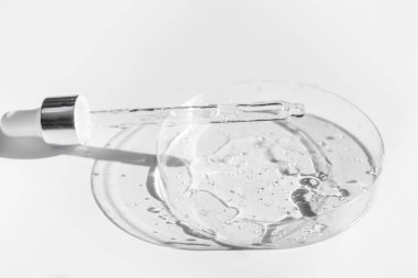 Petri tıbbi kabında pipetli şeffaf sıvı jel ya da hyaluronik serum asidi. Sıvı ve cilt bakımı kavramı