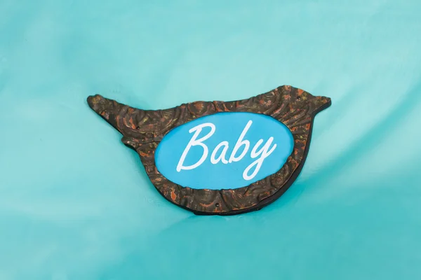 Beautiful wrought bird with the inscription baby — Stock Photo, Image