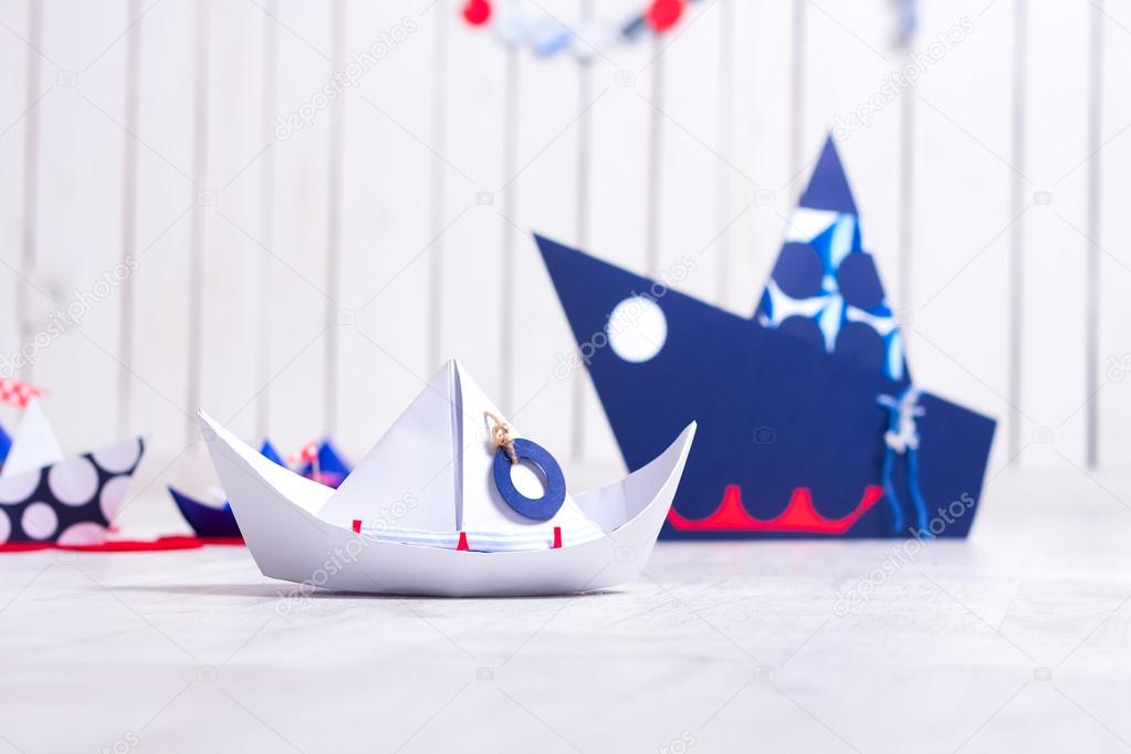 colorful paper boats on the wooden floor