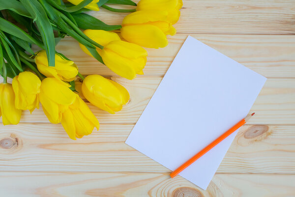 Yellow tulips on a wooden surface