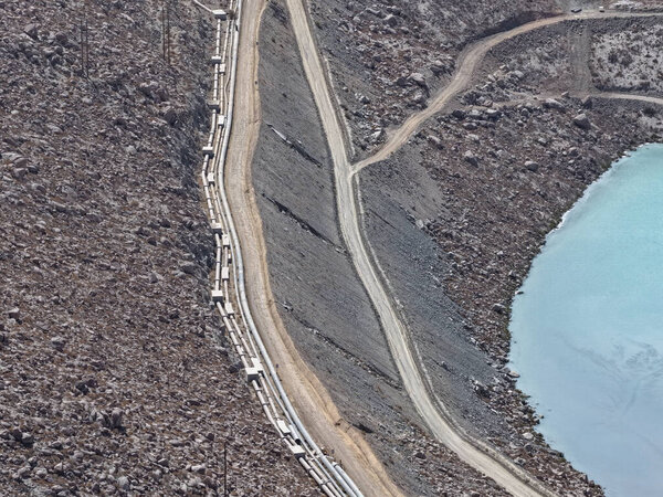 Aerial view of water and mining tailings pipelines to tailings dams