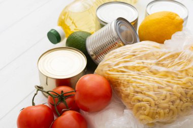 Beyaz ahşap masada çeşitli yiyecekler var. Yiyecek bağışı.