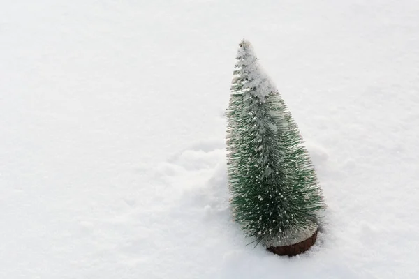 Plastic christmas tree on real snow with copy space. Winter holiday background — Foto Stock