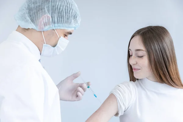 Close up of a Doctor making a vaccination in the shoulder of patient