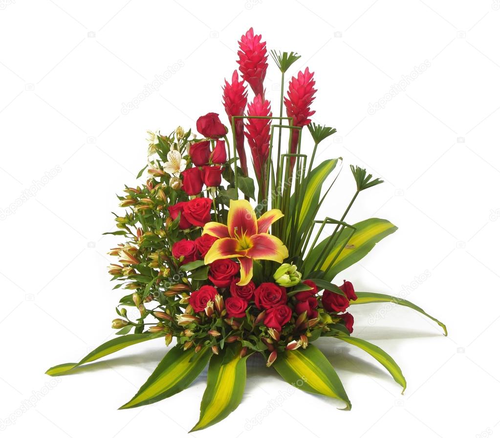 Floral arrangement with red roses and green large leaves on white background
