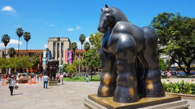 Activity in the Botero Plaza. Sculptures by Fernando Botero, a famous artist from Medellin clipart