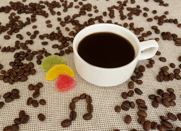 Cup, coffee beans, musical  notes and marshmallow — Stock Photo, Image