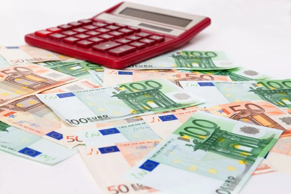 Large calculator on a lot of Euro banknotes cash — Stock Photo, Image