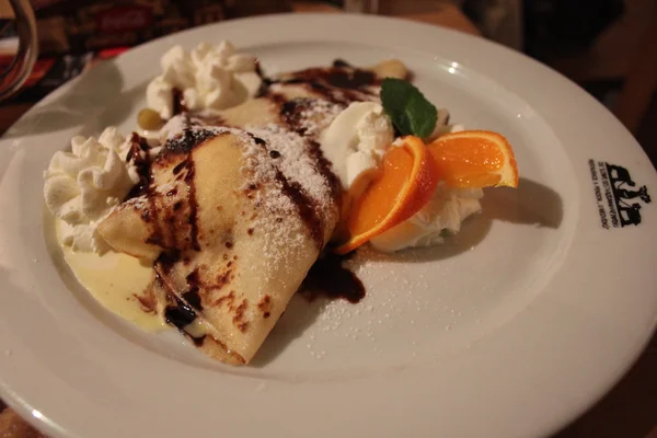 Sweet dessert pancakes in chocolate — Stock Photo, Image