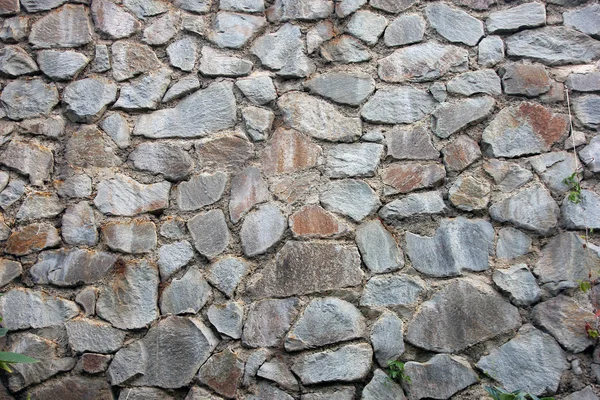 Stone masonry wall from old dilapidated shabby rubble foreground — Stock Photo, Image