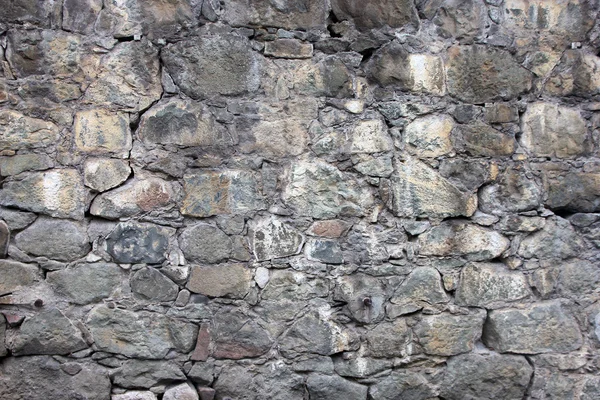 Stone masonry wall from old dilapidated shabby rubble from big l — Stock Photo, Image