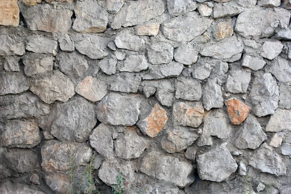 Stone masonry wall from old dilapidated shabby rubble foreground — Stock Photo, Image