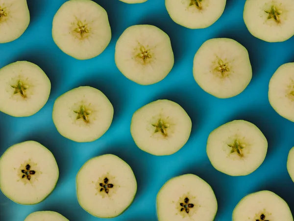 Pattern of sliced green apple. Wallpaper of fruits. Composition of sliced apples.Top view, flat lay.