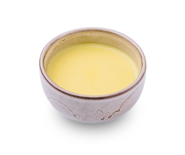 Küçük el yapımı bir kase kremalı sarı bir sos içerir, çeşitli yemekleri geliştirmek için mükemmeldir. Yumuşak dokusu ve zengin rengi yemeklere çekici bir tat kattığını gösteriyor..