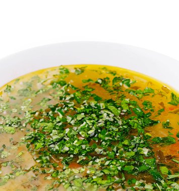 Sıcak bir kase bitkisel çorba üzerinde canlı yeşil bitkiler yüzer. Bu yemek taze malzemeler sergiliyor. Günün her saatinde rahatlamak için ideal..