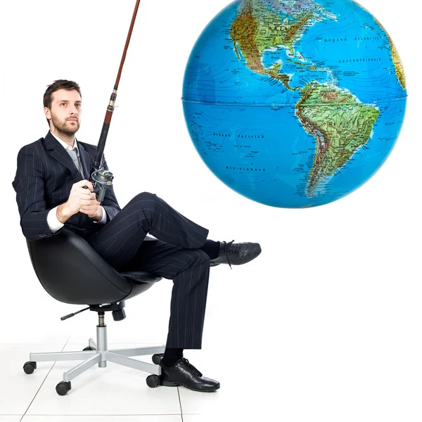 Relaxed businessman own the world fishing globe isolated on white — Stock Photo, Image