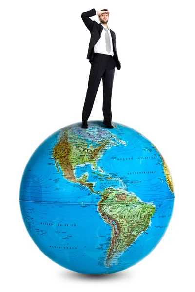 Businessman own the world standing on a globe isolated on white — Stock Photo, Image