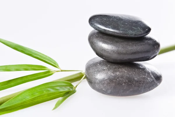 Pila de piedras de terapia de salud spa la stone aislada en blanco con bambú — Foto de Stock
