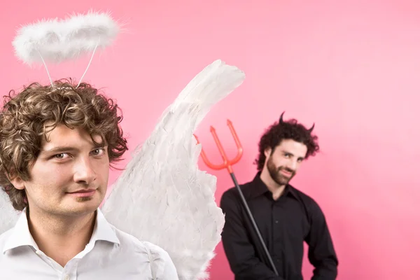 Engraçado anjo branco e preto diabo isolado em rosa — Fotografia de Stock