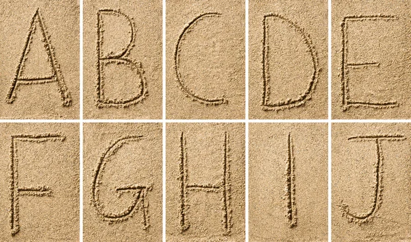 Escritura de arena con alfabeto — Foto de Stock
