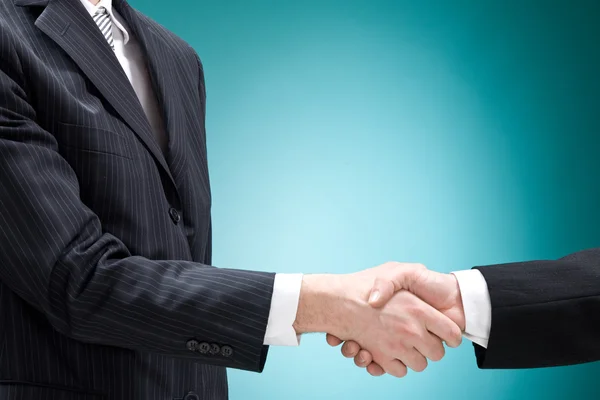 Businessman positive deal with handshake isolated on blue — Stock Photo, Image