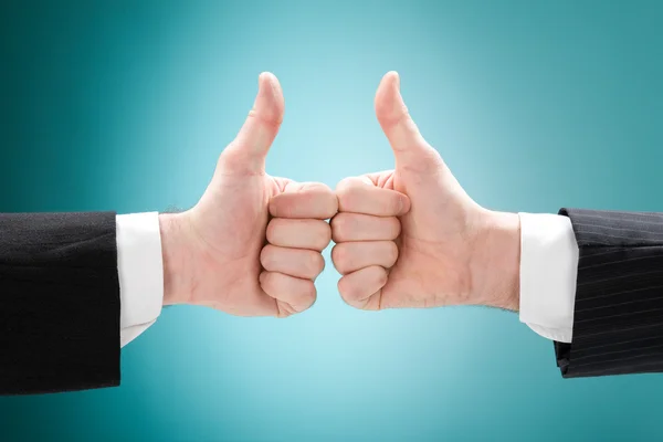 Businessman double thumb up isolated on blue — Stock Photo, Image