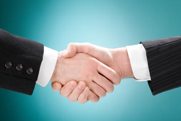 Businessman positive deal with handshake isolated on blue — Stock Photo, Image