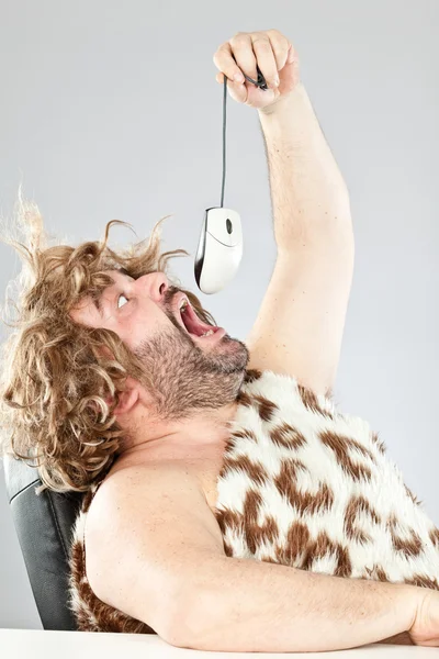Ugly rude prehistoric man eating a mouse — Stock Photo, Image