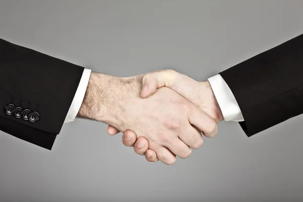 Businessman with suit handshake isolated on grey — Stock Photo, Image