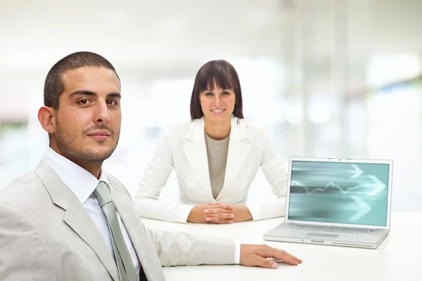 Bell'uomo d'affari con cliente donna e computer portatile in uno sfondo interno — Foto Stock