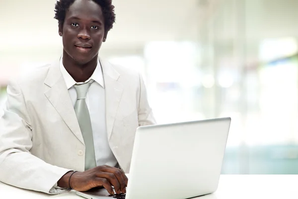 Handsome black businessman with white suit in a interior backgro — Stock Photo, Image