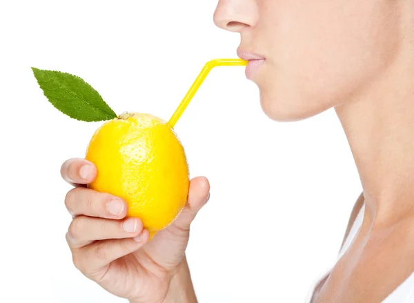 Beautiful girl portrait  drink juice from a lemon isolated on white — Stock Photo, Image