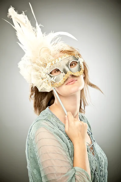 Beautiful blonde girl with old carnival mask isolated on grey — Stock Photo, Image